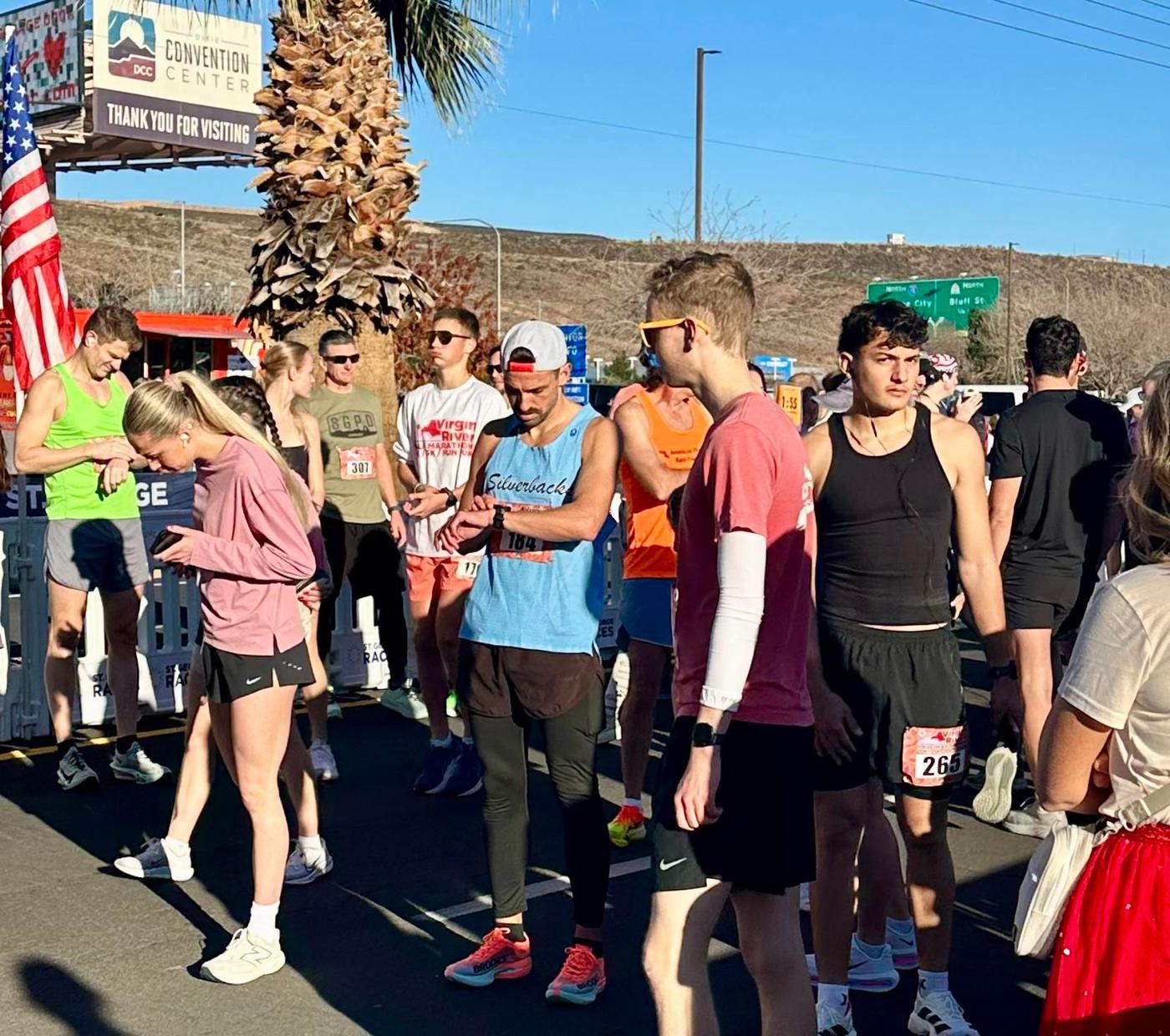 In the start corral at Virgin River, checking a watch among other runners.