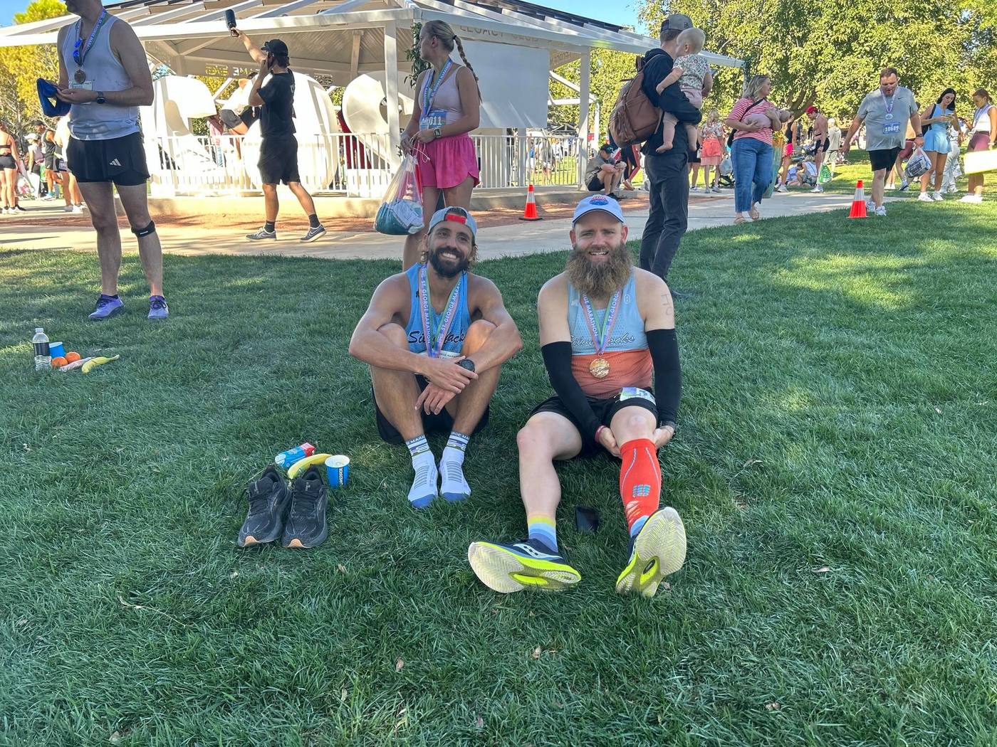 Sitting on the grass after a race, medal on, shoes off.